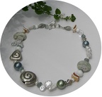 Jasper, rock quartz, pearl, shell and aquamarine with sterling accents create an usual and eye catching necklace.  R08  