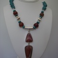 Red jasper sterling double pendent on carnelian with turquoise and sterling silver accents.  Expandable sterling toggle. 